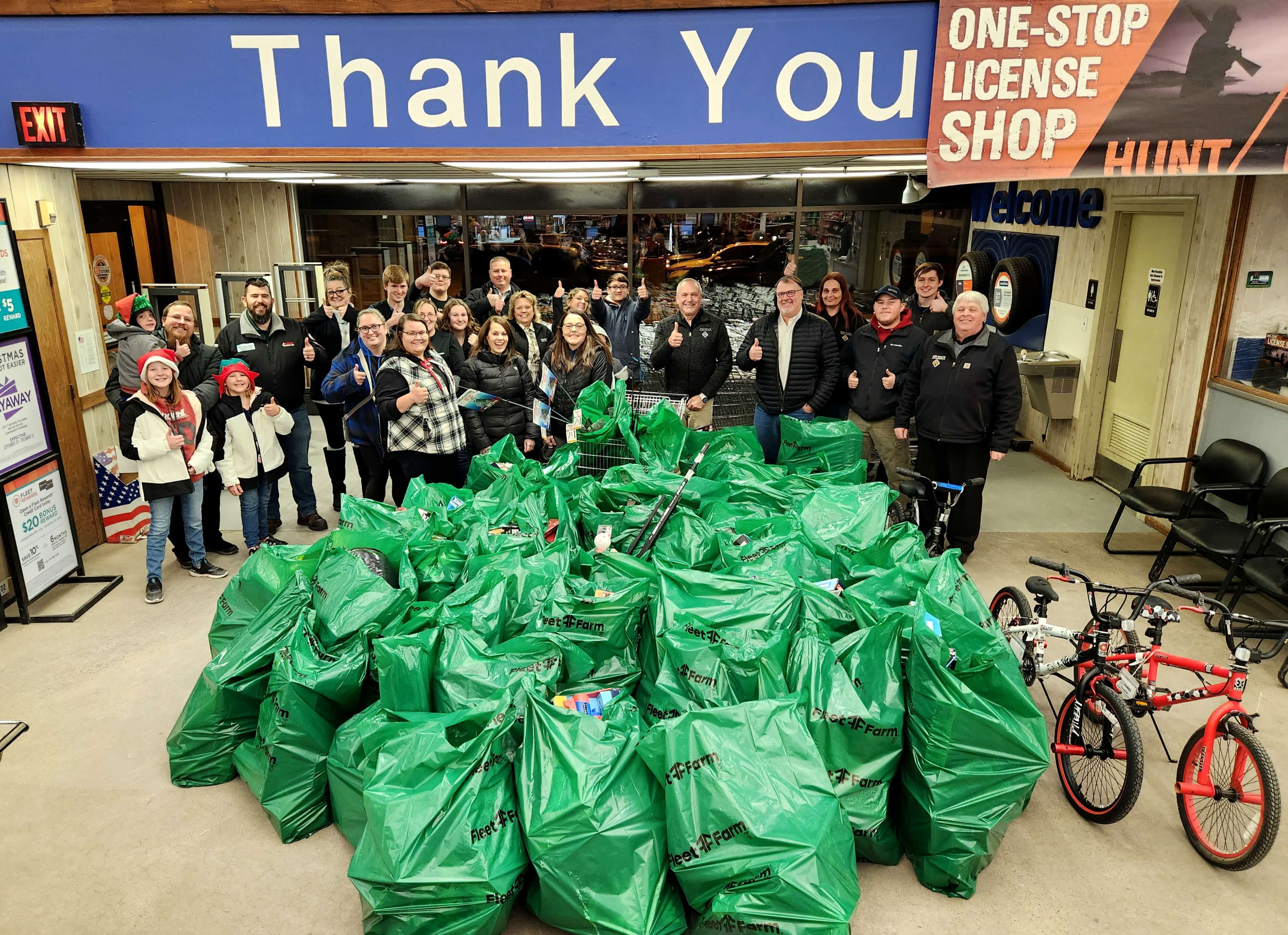 Team members shopping bags of toys at a Toys for Tots shopping event