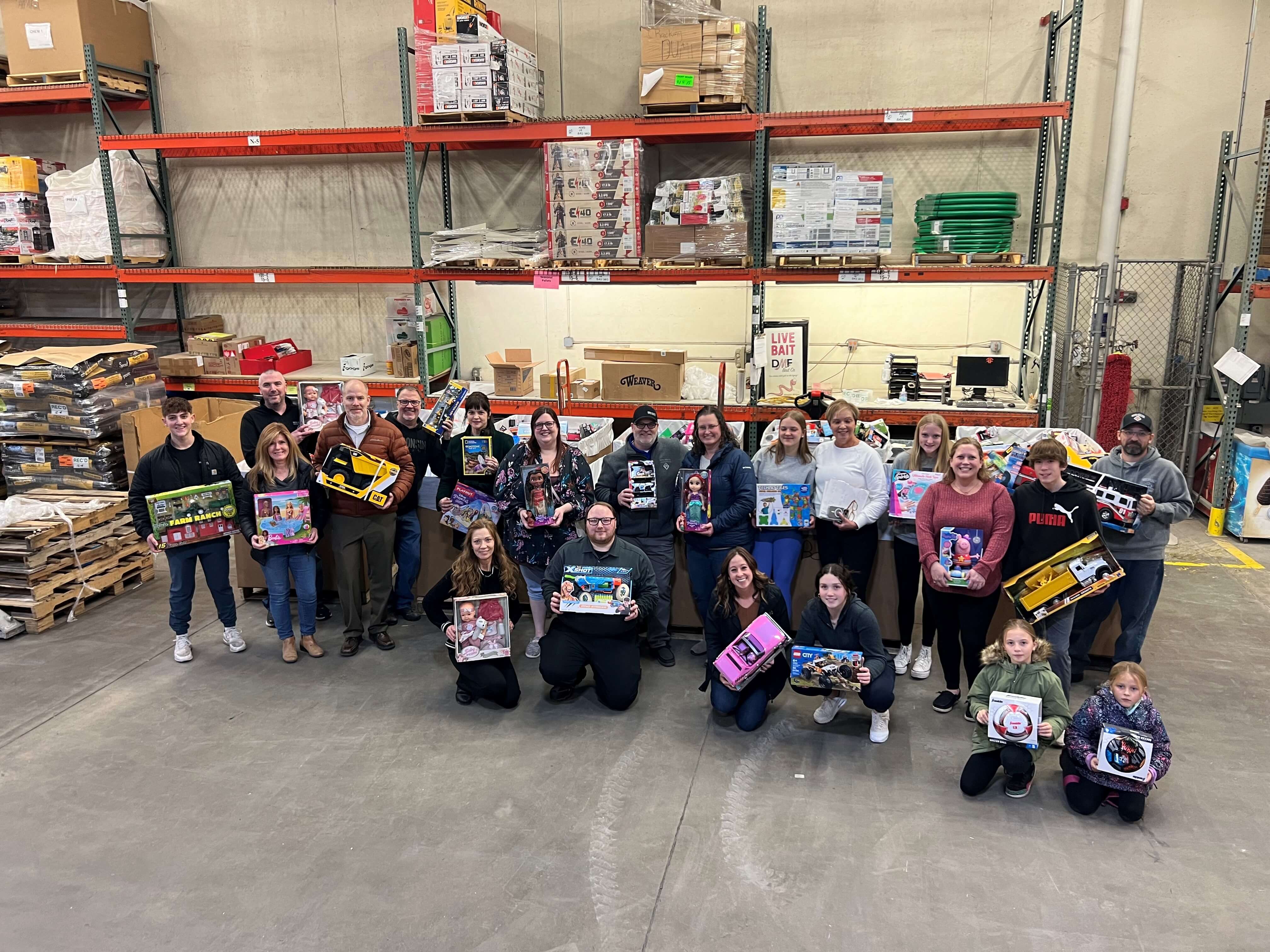 Staff holding toys they picked out